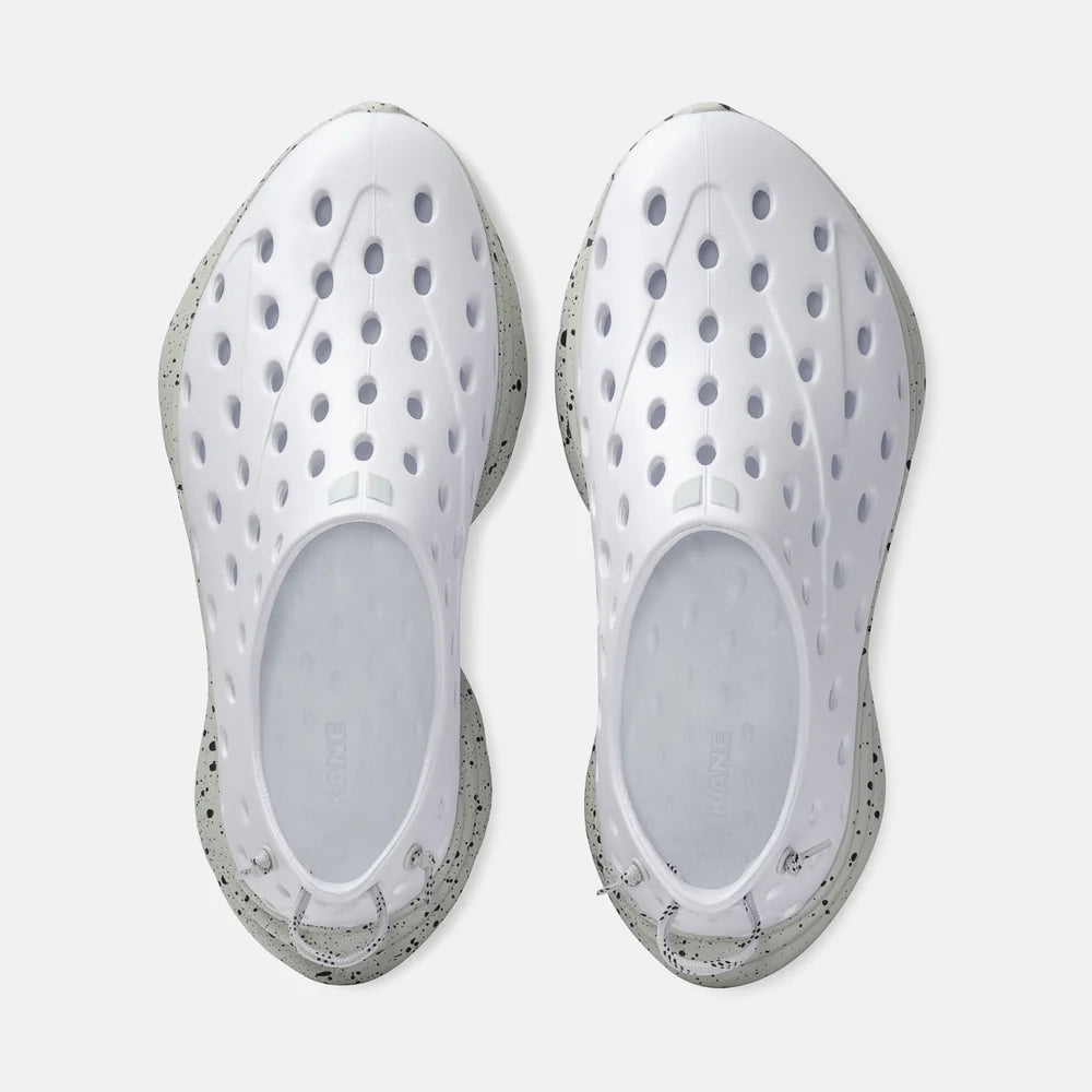 Pair of white Kane Recovery Shoeswith transparent sole on a white background